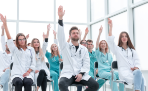 Group of doctors raising hands and asking common questions about locum tenens