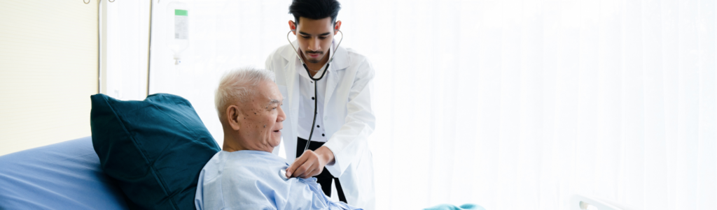 Locum tenens physician checking heartbeat of elderly patient in bed