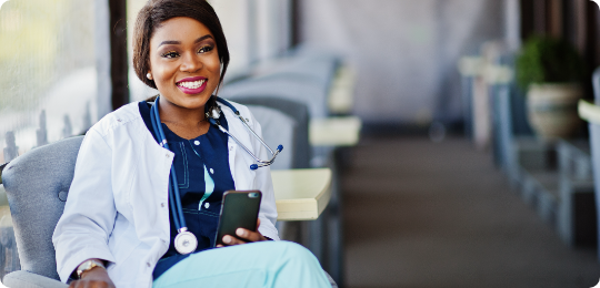Locum tenens nurse practitioner smiling and holding phone