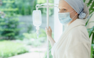 Cancer patient with IV wearing a surgical mask