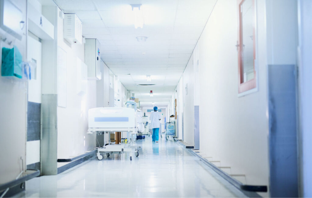 Locum tenens physician walking down a hospital hallway